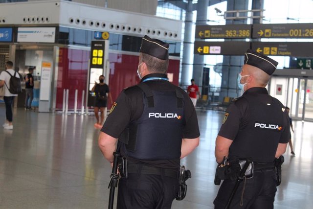Archivo - Dos agentes de la Policía Nacional en el aeropuerto de Málaga-Costa del Sol, en una imagen de archivo