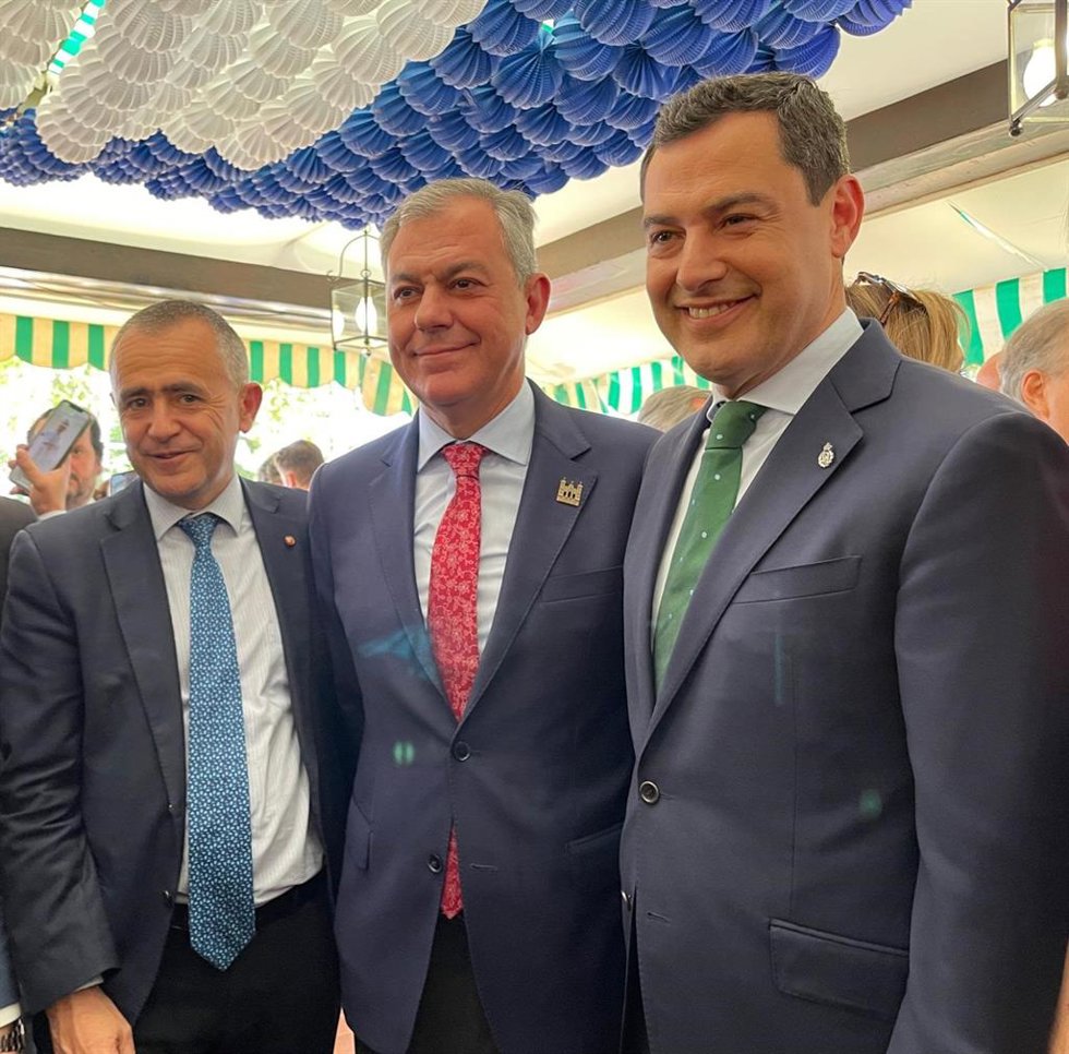 El candidato del PP a la Alcaldía de Sevilla, José Luis Sanz, en el centro, con el presidente de la Junta de Andalucía, Juanma Moreno, en la Feria de Sevilla 2022.