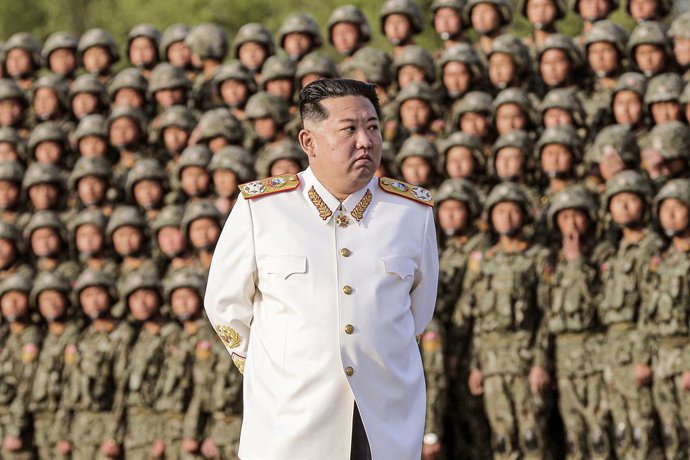 HANDOUT - 27 April 2022, North Korea, Pyongyang: A picture provided by the North Korean state news agency (KCNA) on 29 April 2022, shows North Korean leader Kim Jong-un, wearing a white marshal's uniform, standing in front of soldiers during a photo cal