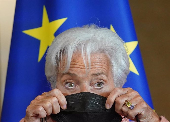 FILED - 27 April 2022, Hamburg: Christine Lagarde, President of the European Central Bank (ECB), puts on an FFP2 mask after being greeted at City Hall. Photo: Marcus Brandt/dpa