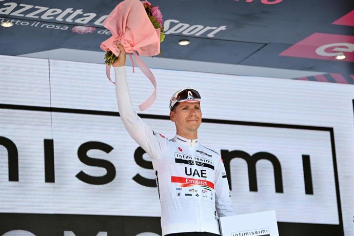 Portuguese cyclist Joao Almeida of UCI WorldTeam UAE celebrates on the podium with white jersey after the 14th stage of the 105th edition of the Giro d'Italia cycling race, 147 kilometers from Santena to Turin