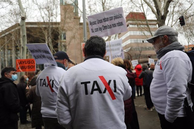 Archivo - Varias personas de Élite Taxi; plataforma por y para la defensa del taxi, se manifiestan contra la ley Ómnibus frente a la Asamblea de Madrid