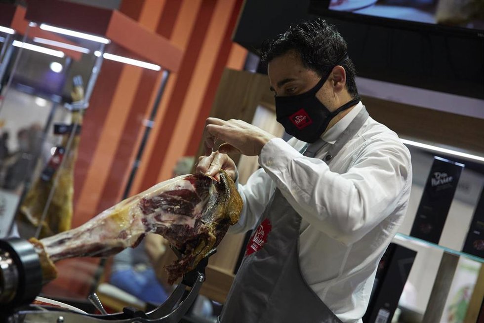 Archivo - Una persona corta jamón en la XXXIV edición del Salón Gourmets 