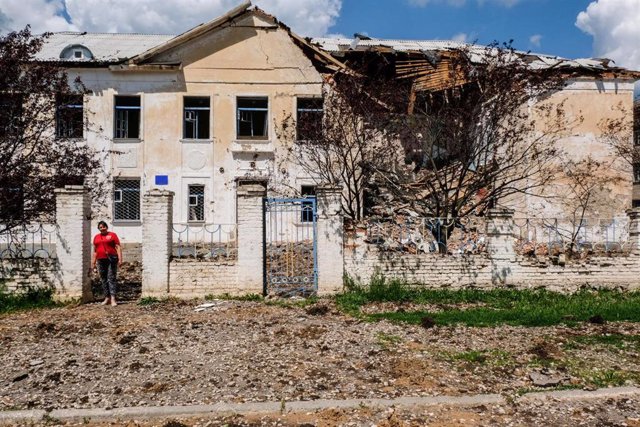 Una profesora frente a una escuela destruida por un misil en Verjnokmayanske, en la región de Donetsk, en el este de Ucrania