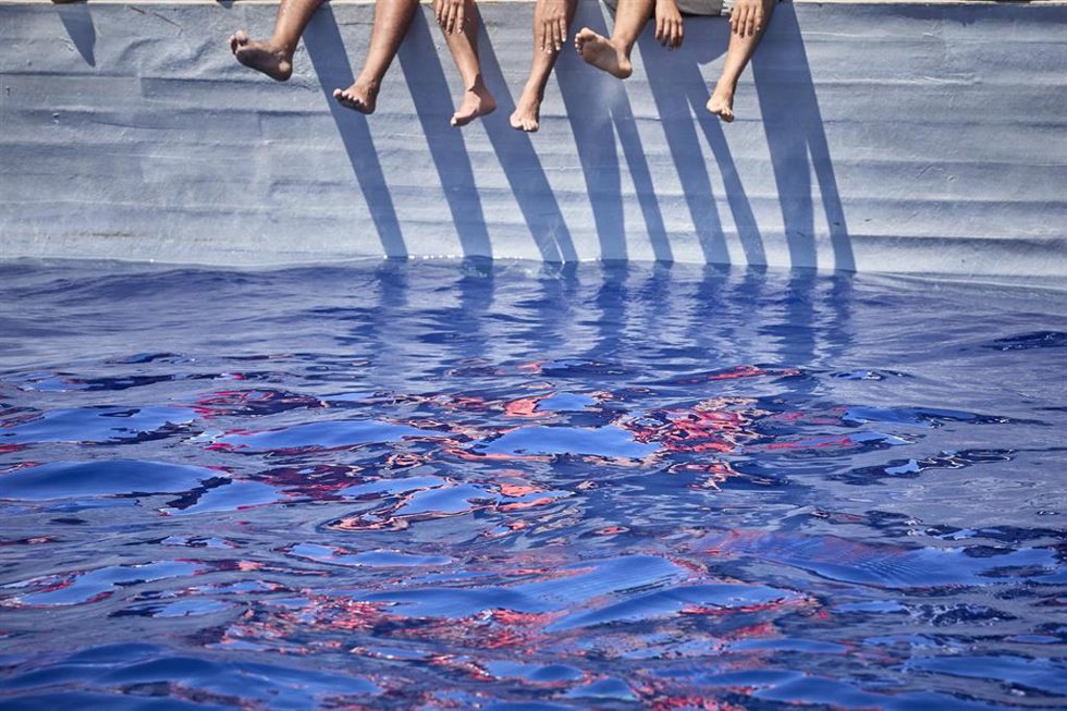 Archivo - Varios de los migrantes que viajan en una patera avistada por la ONG Open Arms desde el barco 'Astral', a 8 de septiembre de 2021.