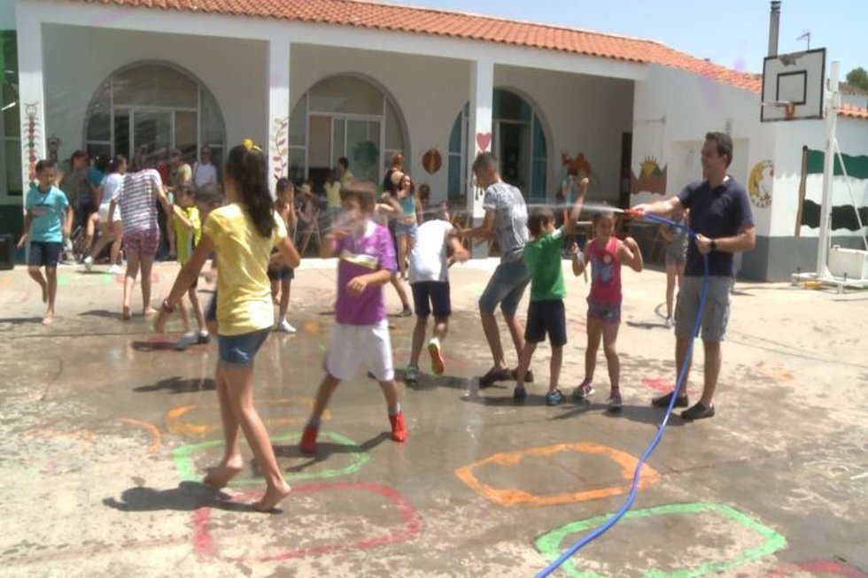 Archivo - Un maestro refresca a alumnos en un colegio extremeño.