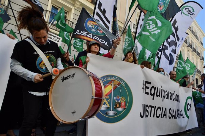 Varias personas se manifiestan con pancartas de Justicia Salarial Policial (JUSAPOL) durante una concentración en Madrid