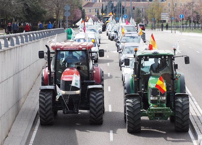 Archivo - Una caravana de coches encabezada por dos tractores 