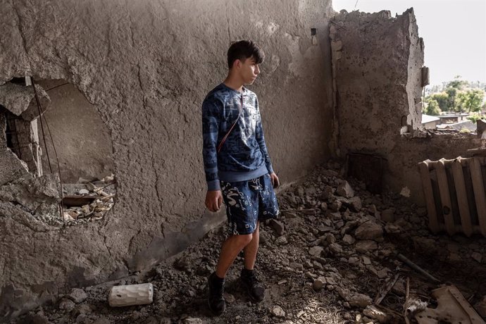 June 16, 2022, Irpin, Kiev, Ukraine: Arseniy, a collage student poses in what was left from his bedroom in an apartment of a residential building destroyed by bombardment. As the Russian Federation invaded Ukraine nearly four months ago, fierce fighting