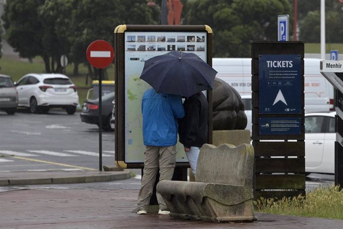 Dos personas se resguardan de la lluvia con paraguas, a 19 de junio de 2022, en A Coruña, Galicia, (España). La inestabilidad se mantendrá en Galicia al menos hasta la mitad de la semana que viene. A partir de mañana lunes 20 de junio  el descenso térmi