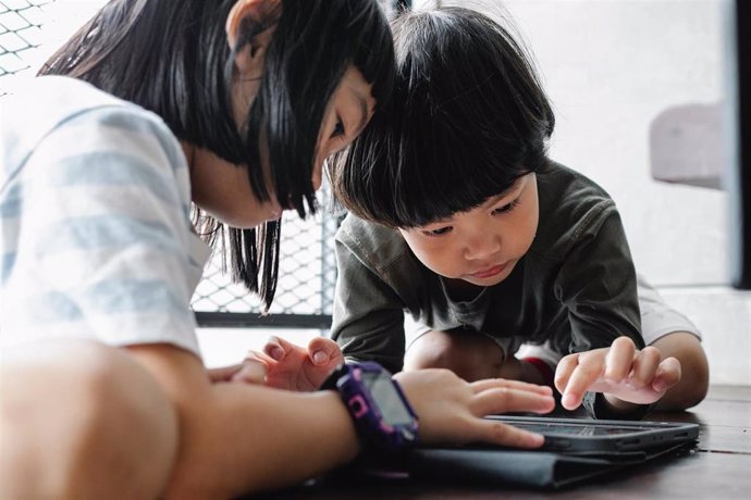 Dos niños utilizando una tableta