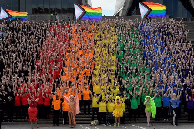 Close to 1,000 participates dress in colours to create the LGBTQIA+ Progress Flag on the steps of the Sydney Opera House during the anniversary of the first Sydney Gay and Lesbian Mardi Gras in 1978, Sydney, Friday, June 24, 2022. (AAP Image/Bianca De Mar