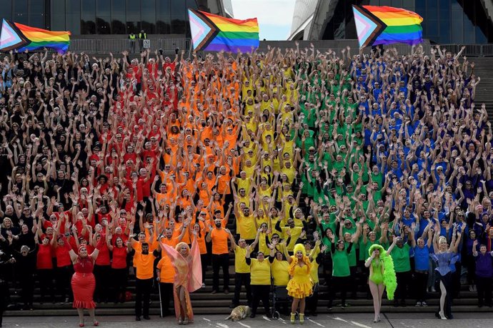 Close to 1,000 participates dress in colours to create the LGBTQIA+ Progress Flag on the steps of the Sydney Opera House during the anniversary of the first Sydney Gay and Lesbian Mardi Gras in 1978, Sydney, Friday, June 24, 2022. (AAP Image/Bianca De M