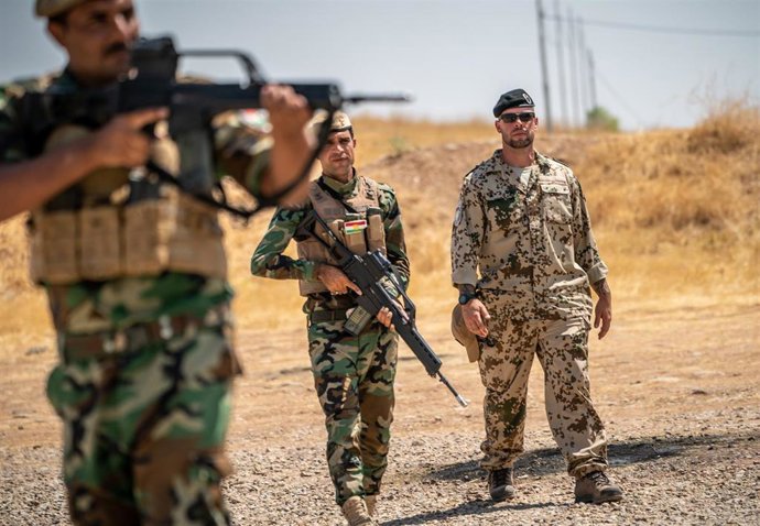 Archivo - Un soldado alemán junto a varios peshmerga.