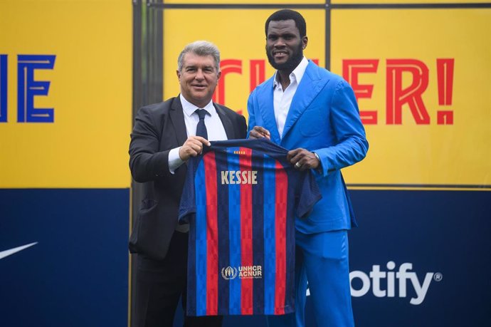 Ivorian midfielder Franck Kessie (R)and Joan Laporta, president of FC Barcelona, pose with the team's jersey during Kessie presentation as a new player
