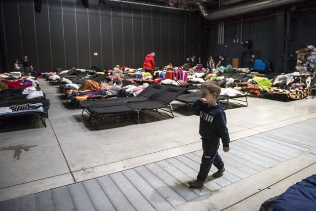 Archivo - April 19, 2022, Warsaw, Mazowieckie, Poland: A child is walking by the camp beds at the Global Expo refugee reception centre in Warsaw.