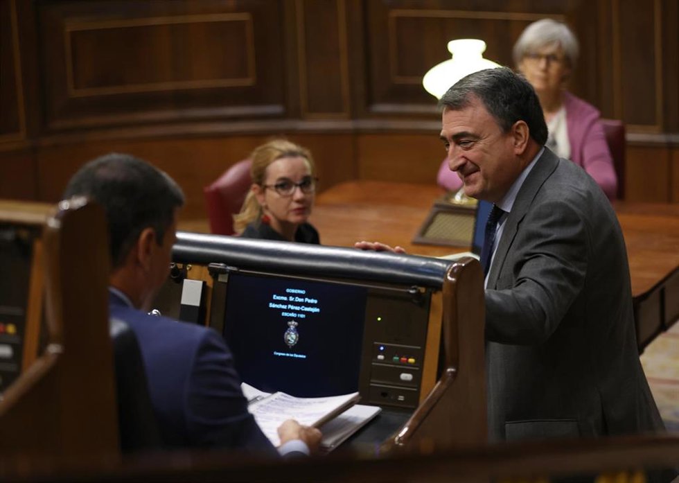 El presidente del Gobierno, Pedro Sánchez (i), y el portavoz del PNV en el Congreso, Aitor Esteban, conversan en la segunda jornada de la 26 edición del Debate sobre el Estado de la Nación, en el Congreso de los Diputados, a 13 de julio de 2022, en Madr