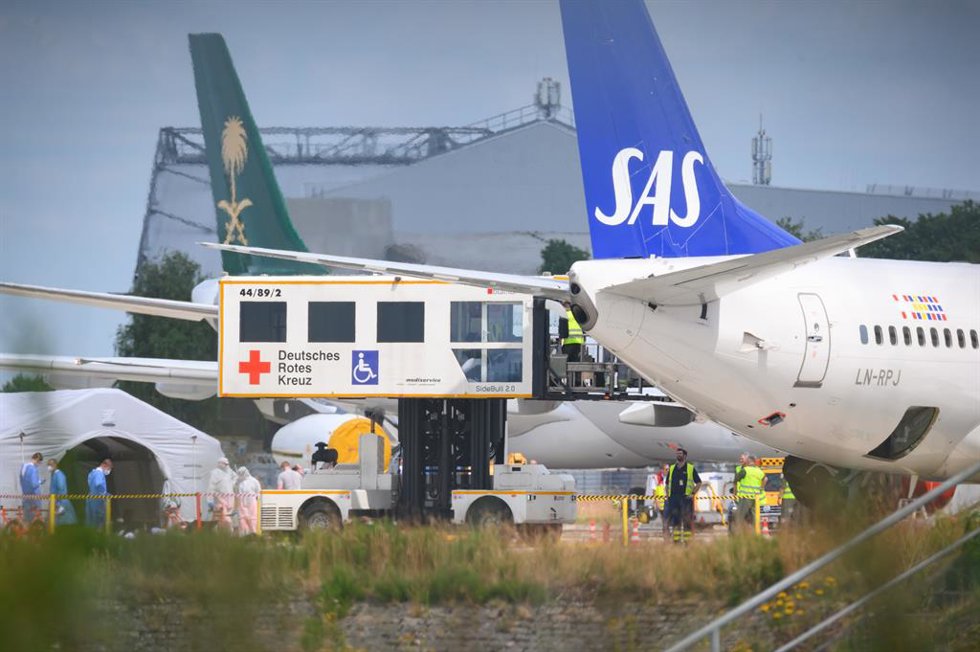 30 June 2022, Hamburg: A lift truck of the DRK (German Red Cross) stands by the SAS aircraft on the apron during the unloading of patients. An aircraft brought injured people from Ukraine to northern Germany on Thursday. Photo: Jonas Walzberg/dpa