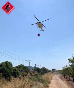 Un helicóptero trabaja en un incendio forestal en la ciudad de Alicante, en la zona del depósito de agua de La Canyada
