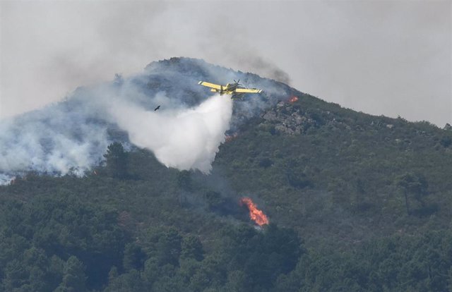 Un hidroavión anfibio echa agua sobre la vegetación afectada por el incendio en la comarca de Las Hurdes (Cáceres).  