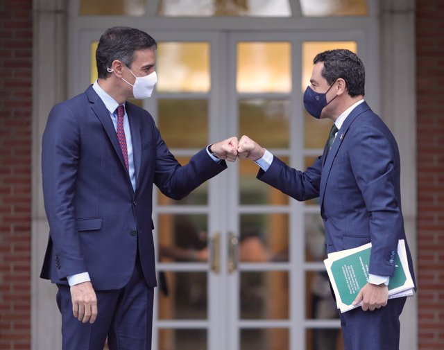 El presidente del Gobierno, Pedro Sánchez (i), saluda con el puño al presidente de la Junta de Andalucía, Juan Manuel Moreno Bonilla, a su llegada al Palacio de la Moncloa, a 17 de junio de 2021.