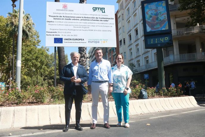 José María Bellido (centro), entre Salvador Fuentes y Blanca Torrent, ante el cartel que anuncia las obras de asfaltado para atenuar el ruido del tráfico en el centro de la ciudad.