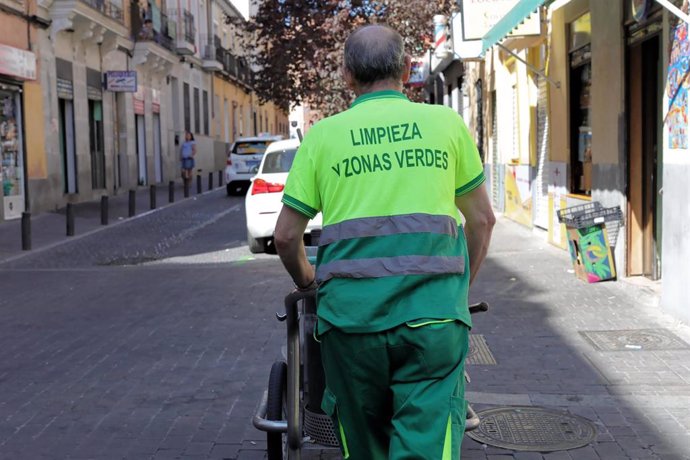 Archivo - Un barrendero del Ayuntamiento de Madrid empuja su carro de la limpieza, mientras trabaja en una calle del centro de la ciudad.