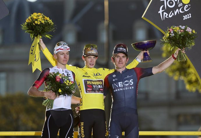 Second place Tadej Pogacar of Slovenia and UAE Team Emirates, winner and yellow jersey Jonas Vingegaard of Denmark and Jumbo - Visma, third place Geraint Thomas of Great Britain and Ineos Grenadiers during the podium ceremony following stage 21 of the T