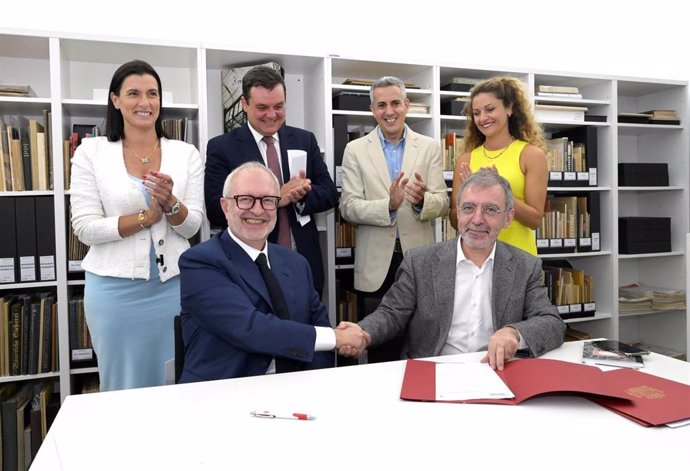 El director del Museo Reina Sofía, Borja-Villel (abajo a la derecha), y el coleccionista José María Lafuente (izda) se estrechan la mano tras firmar el contrato de compraventa del Archivo Lafuente, que pasa a manos del Estado, en presencia de autoridades