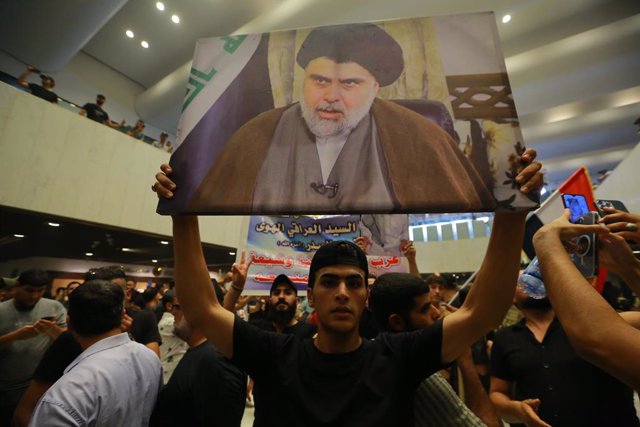 27 July 2022, Iraq, Baghdad: Supporters of Iraq's influential Shiite cleric Moqtada al-Sadr protest inside the Parliament building after breaching the Baghdad's fortified Green Zone, which houses parliament and many embassies, to demand political reforms 