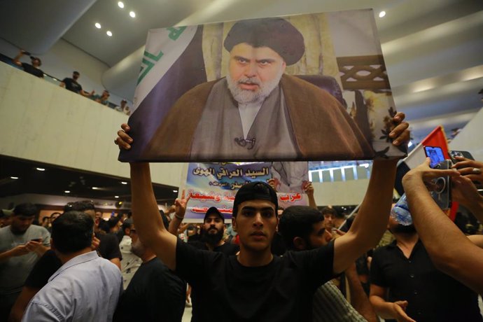 27 July 2022, Iraq, Baghdad: Supporters of Iraq's influential Shiite cleric Moqtada al-Sadr protest inside the Parliament building after breaching the Baghdad's fortified Green Zone, which houses parliament and many embassies, to demand political reform