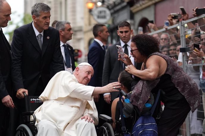 28 July 2022, Canada, Quebec: Pope Francis greets Evangelista Herrera (in wheelchair) as he arrives at the Cathedral-Basilica of Notre-Dame de Quebec in Quebec City to preside over an evening prayer service during his papal visit across Canada. Photo: N