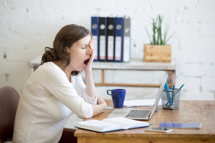 Archivo - Sleepy young worker woman yawning