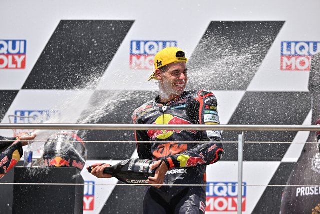 19 June 2022, Saxony, Hohenstein-Ernstthal: Spanish rider Augusto Fernandez of the Red Bull KTM Ajo celebrates on the podium after winning the Moto2 race of the MotoGP of Germany at the Sachsenring racing track. Photo: Hendrik Schmidt/dpa