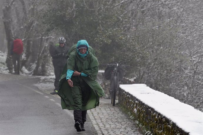 Archivo - Varios peregrinos llegan a O Cebreiro con nieve, a 20 de abril de 2022, en O Cebreiro, Lugo