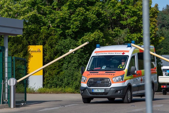 11 August 2022, Bavaria, Guenzburg: An ambulance drives past the entrance to Legoland Germany after an accident on a roller coaster at Legoland. Photo: Stefan Puchner/dpa