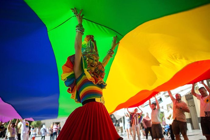 Archivo -  drag queen bajo una bandera gigante LGTBIQ+ durante el desfile del Orgullo LGBT