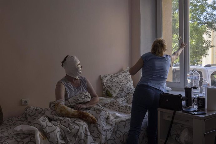 Jul 15, 2022 - Vinnytsia, Vinnytsia Oblast, Ukraine - RYNA VOLKOVA, 49, who was badly burned as a result of a missile strike, sits while her sister closes the window, after receiving treatment in a ward in the burns unit of a hospital in Vinnytsia.