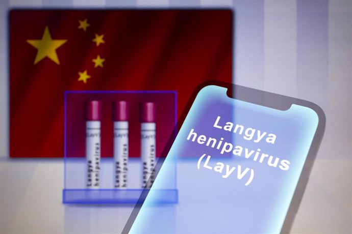 10 August 2022, Paraguay, Asuncion: The words "Langya henipavirus (LayV)" are seen displayed on a smartphone in front of visual representation of test tubes backdropped by the flag of China. Photo: Andre M. Chang/ZUMA Press Wire/dpa