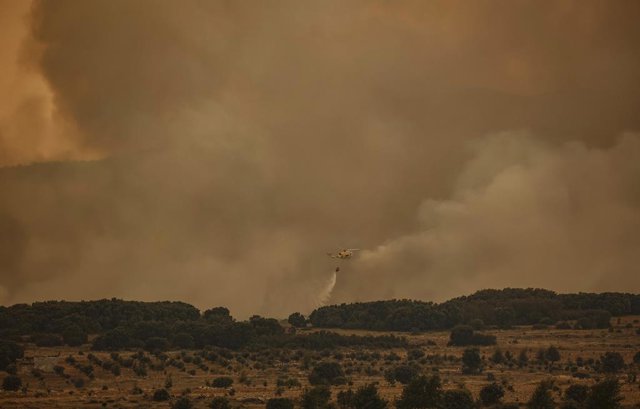 Un helicòpter contra incendis treballa en les tasques d'extinció de l'incendi de Begís