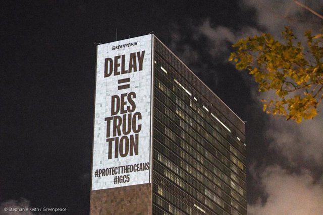 Greenpeace USA activists project messages calling for ocean protection onto the United Nations building.
