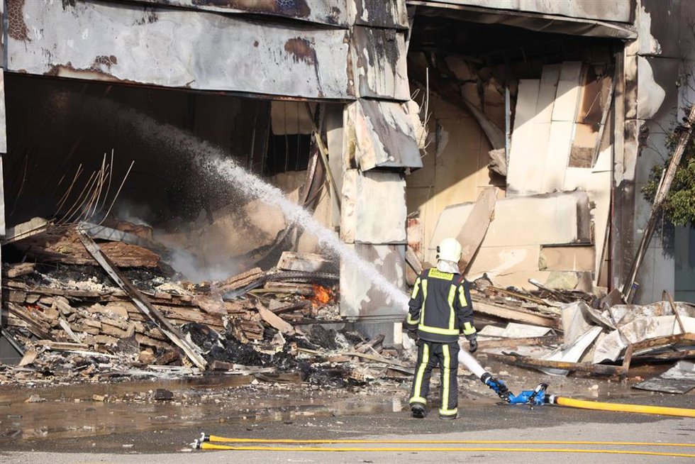 Un bombero durante las labores de extinción de la nave de plásticos que ardió en Utrera (Sevilla).