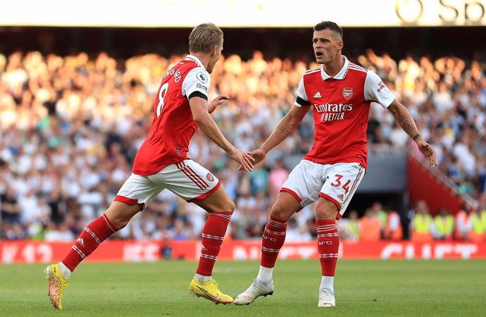 27 August 2022, United Kingdom, London: Arsenal's Martin Odegaard (L) celebrates scoring their side's first goal with team-mate Granit Xhaka during the English Premier League soccer match between Arsenal and Fulham at the Emirates Stadium. Photo: Bradle