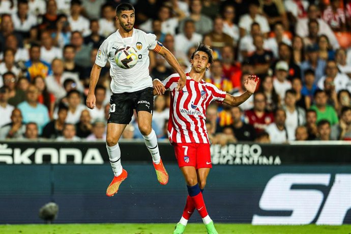 Carlos Soler of Valecia and Joao Felix of Atletico de Madrid in action during the Santander League match between Valencia CF and Atletico de Madrid at the Mestalla Stadium on August 29, 2022, in Valencia, Spain.