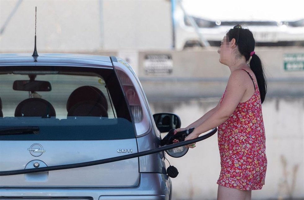 Archivo - Una pasajera reposta en una gasolinera a la altura de Rivas