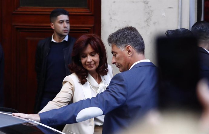 23 August 2022, Argentina, Buenos Aires: Current vice-president and former president of Argentina Cristina Fernandez de Kirchner (L) leaves her home. A prosecutor asked for 12 years in prison for Fernandez de Kirchner after accusing her in a corruption 