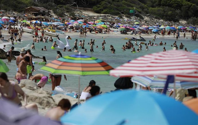 Turistas en Cala Agulla.