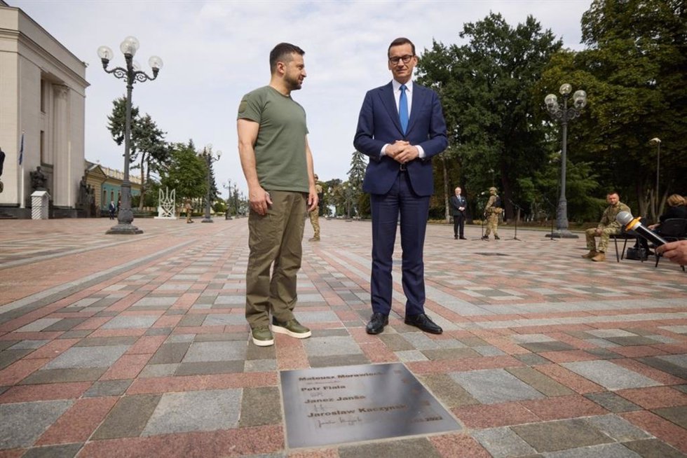 El presidente de Ucrania, Volodimir Zelenski, junto con el primer ministro polaco, Mateusz Morawiecki, frente a una placa en homenaje a los primeros líderes europeos que visitaron Kiev tras el inicio de la guerra