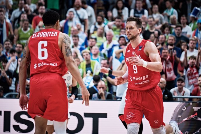 Mateusz Ponitka y AJ Slaughter durante el Eslovenia-Polonia del Eurobasket 2022