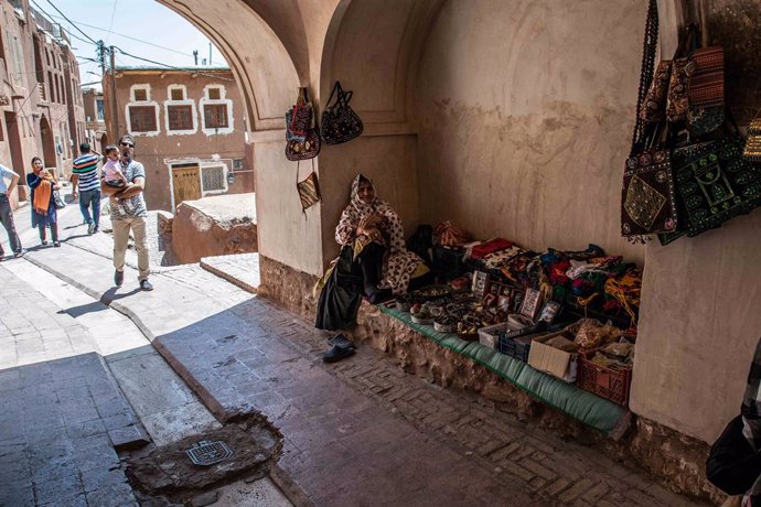 Archivo - September 5, 2017 - An old woman sells her craft items to the door of her house, dressed in her traditional white handkerchief and painted red or yellow flowers. The people of Abyaneh still preserve the old traditions like the language, one of